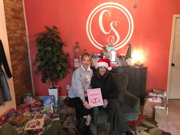 Women United Donates Books & Puzzles For Holiday Food Boxes