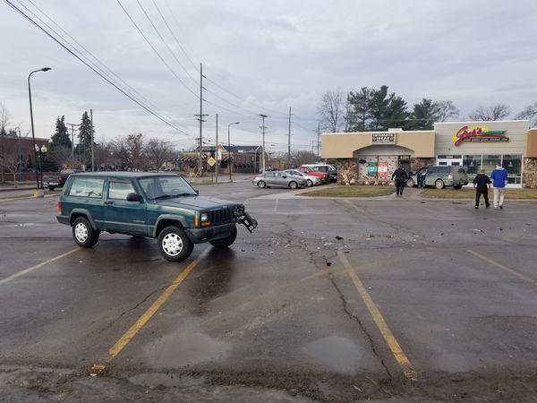 SUV Crashes Into Parked Jeep, Comes To Rest Against Brighton Plaza Building