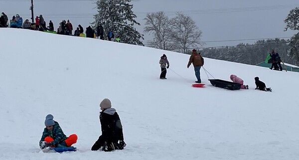 Students Enjoy Snow Day On Sledding Hill At Genoa Park